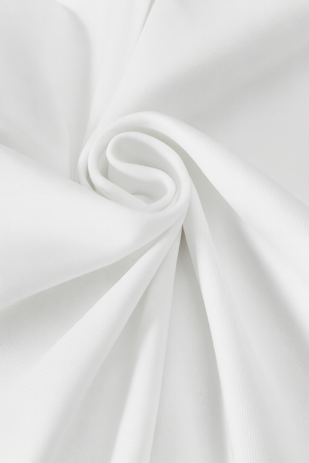 Close-up of white fabric with folds on a light gray background